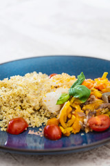 Cooked rice with vegetables, cod and lemon sauce