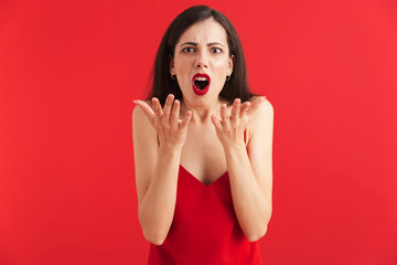 Portrait of a shocked young woman in dress