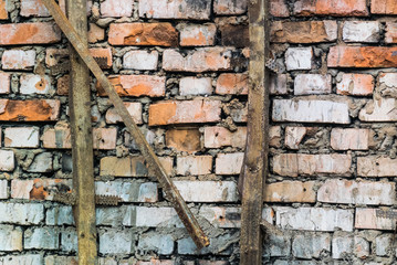 Photo texture of the old weathered brick wall and with the letter 
