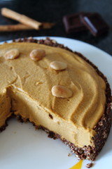 Fresh homemade pumpkin pie made for Thanksgiving with cinnamon and chocolate.