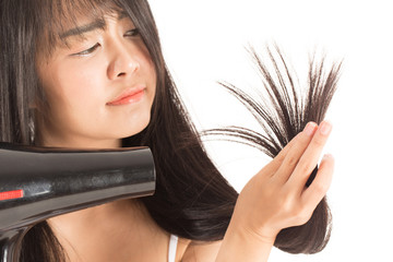 woman holding hair dryer and looking damaged hair she so serious and worries,Isolated on white...