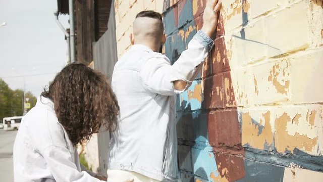 Woman having fun with boyfriend teasing him and spending time together on city street