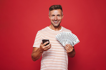 Portrait of a smiling man standing over red background