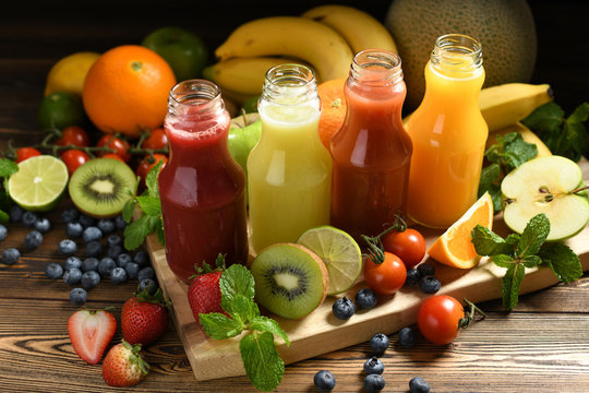 Various fresh fruits and vegetables smoothies in bottles