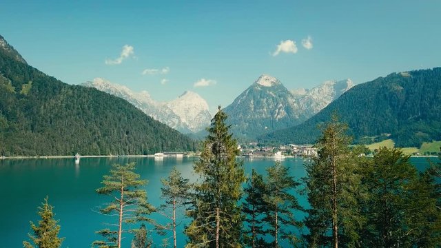 Aerial flight lake and mountain alps peaks landscape view, in summer sunny day with blue sky
