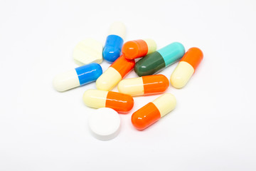 Group of capsuals and drugs on white background.