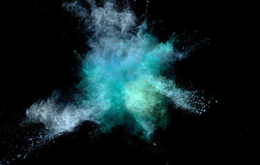 Explosion of coloured powder on black background.