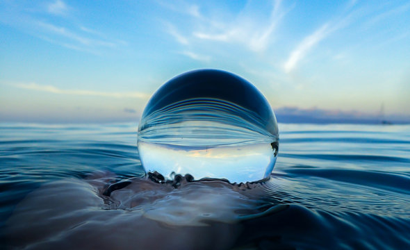 Ocean Surface Ripples and Clouds in Sky Captured in Glass Ball