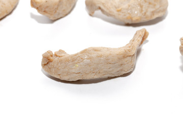 close up of raw fish ball on white background