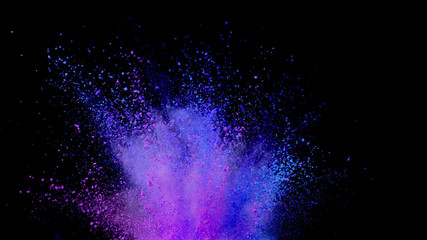 Explosion of coloured powder on black background.