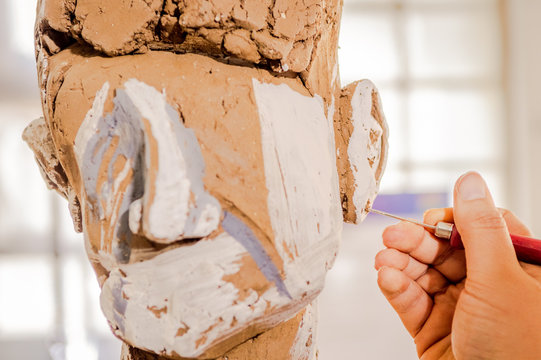 Woman working on a sculpture