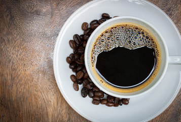 fresh black coffee top view on wood table