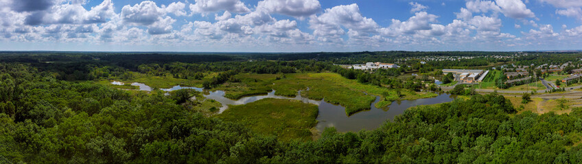 Fototapeta na wymiar Top view of the river by trees and meadows on beautiful garden or park with trees
