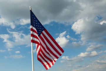 American Flag Waving Against Blue Sky