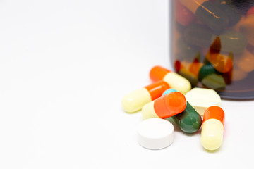 Group of pills and capsules close up on white background, concept of medical and health care.