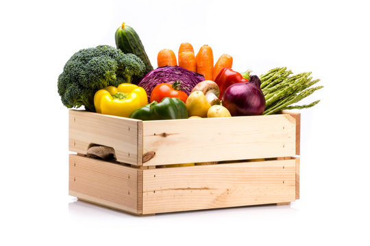 Fototapeta Pine box full of colorful fresh vegetables on a white background