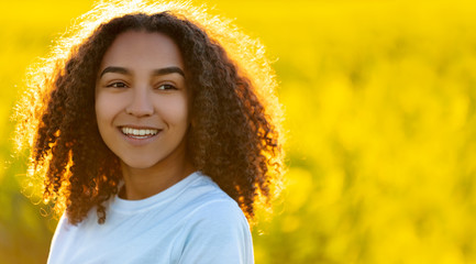 Happy Mixed Race African American Teenager Woman in Yellow Flowers