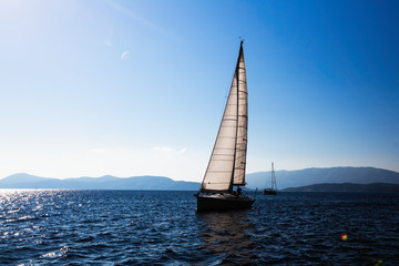 Fototapeta na wymiar Sailing ship luxury yacht with white sails in the Sea.