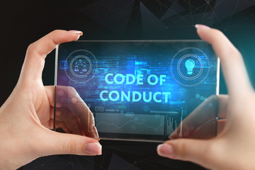 The concept of business, technology, the Internet and the network. A young entrepreneur working on a virtual screen of the future and sees the inscription: Code of conduct