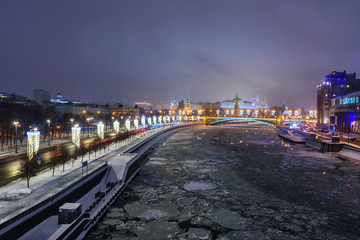Fototapeta na wymiar View of Moscow Kremlin and Bolshoy Kamenny Bridge from Patriarshy Bridge at night in winter. Moscow. Russia