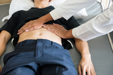 Doctor check stomach of patient in hospital