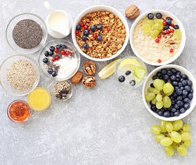 Breakfast food table. Plant based breakfast or brunch set, meal variety with  overnight oats, granola , fresh berries and various of topping. Overhead view, copy space