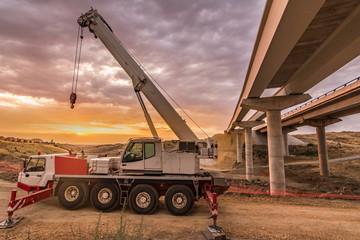 Mobile crane building a highway bridge