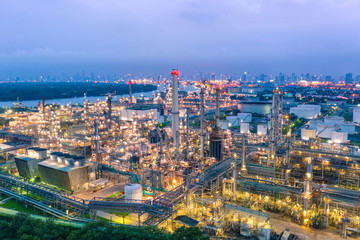 Industrial view at oil refinery plant form industry zone with sunrise and cloudy sky.Oil refinery and Petrochemical plant at dusk,Thailand. Aerial view