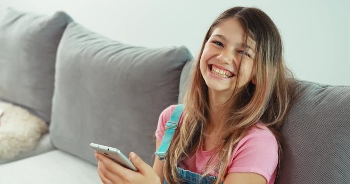 Teenage using cellphone and smiling