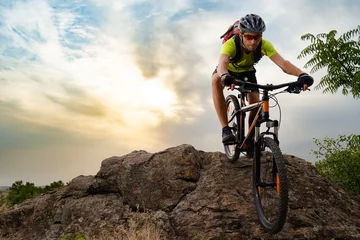 Foto op Canvas Cyclist Riding the Bike on Autumn Rocky Trail at Sunset. Extreme Sport and Enduro Biking Concept. © Maksym Protsenko