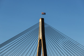 Australian flag at the top of suspension bridge.