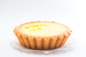 One single lemon tart, isolated on white.