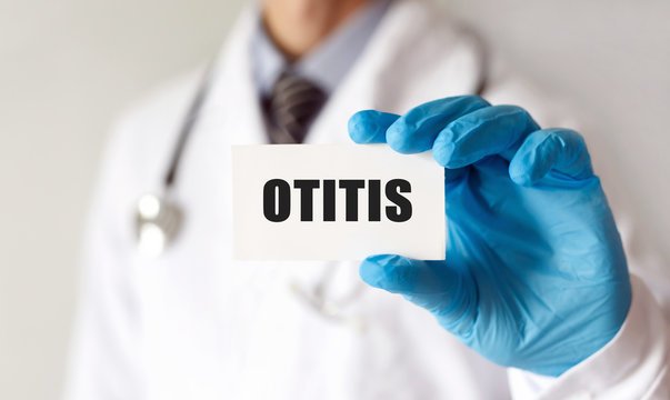 Doctor holding a card with text Otitis, Medical concept