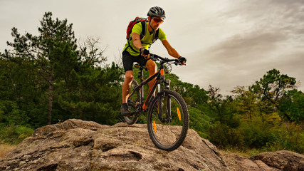 Plakat Cyclist Riding the Bike on Autumn Rocky Trail at Sunset. Extreme Sport and Enduro Biking Concept.