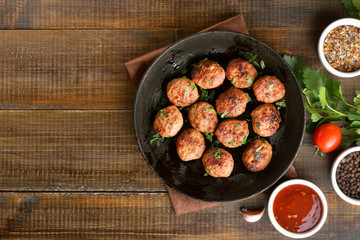 Fried meatballs in cast iron pan - obrazy, fototapety, plakaty