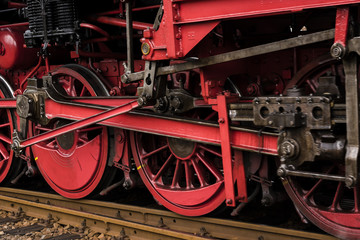 Fototapeta na wymiar Rod drive of a steam locomotive, Big Steam Locomotive, Red Wheels of a Steam Locomotive, Details