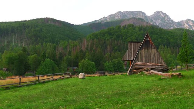Poland,Zakopane, View of the highlander hut. In the background of mountains TATRY, Clouds. Trees and meadows. Sleeping knight and cross at Giewont. Sunrise. Panning camera, Pan, Closeup