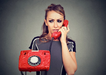 Worried woman receiving bad news on a phone