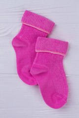 Pair of pink wool winter socks for newborn baby.