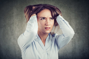 Stressful woman squeezing head