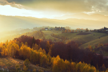 Naklejka na ściany i meble Magic autumn sunset light in Transylvania. Warm october evening