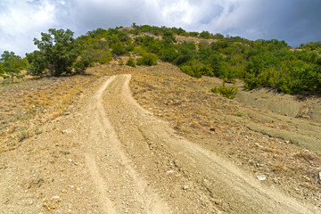 Steep descent on a dirt road.