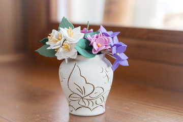 bouquet of flowers in a vase on wooden windowsill