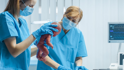 In the Hospital Woman in Labor Pushes and Gives Birth, Baby Comes out, Obstetricians Assist...