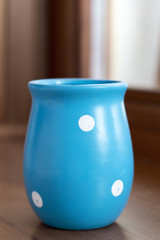 blue vase (polka-dot) on wooden windowsill