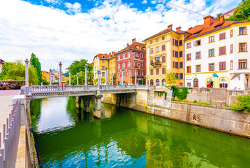 Ljubljana old town center, view of Ljubljanica river in city center. Old building historic panorama. Look to old bridge with tourist.
