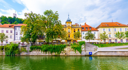 Ljubljana old town center, view of Ljubljanica river in city center. Old building historic panorama. Look to old bridge with tourist.