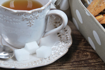 tea for breakfast in retro cups with sugar cubes and cookies baked at home