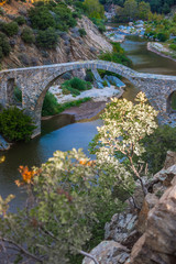 Fototapeta na wymiar Arch Byzantine stone bridge over Kompsatos river in Rodopi, Greece