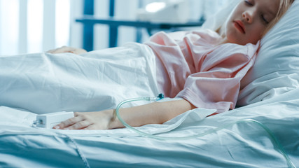 Cute Little Sick Girl Sleeps on a Bed in the Children's Hospital. Modern Pediatric Ward with Top Quality Health Care.
